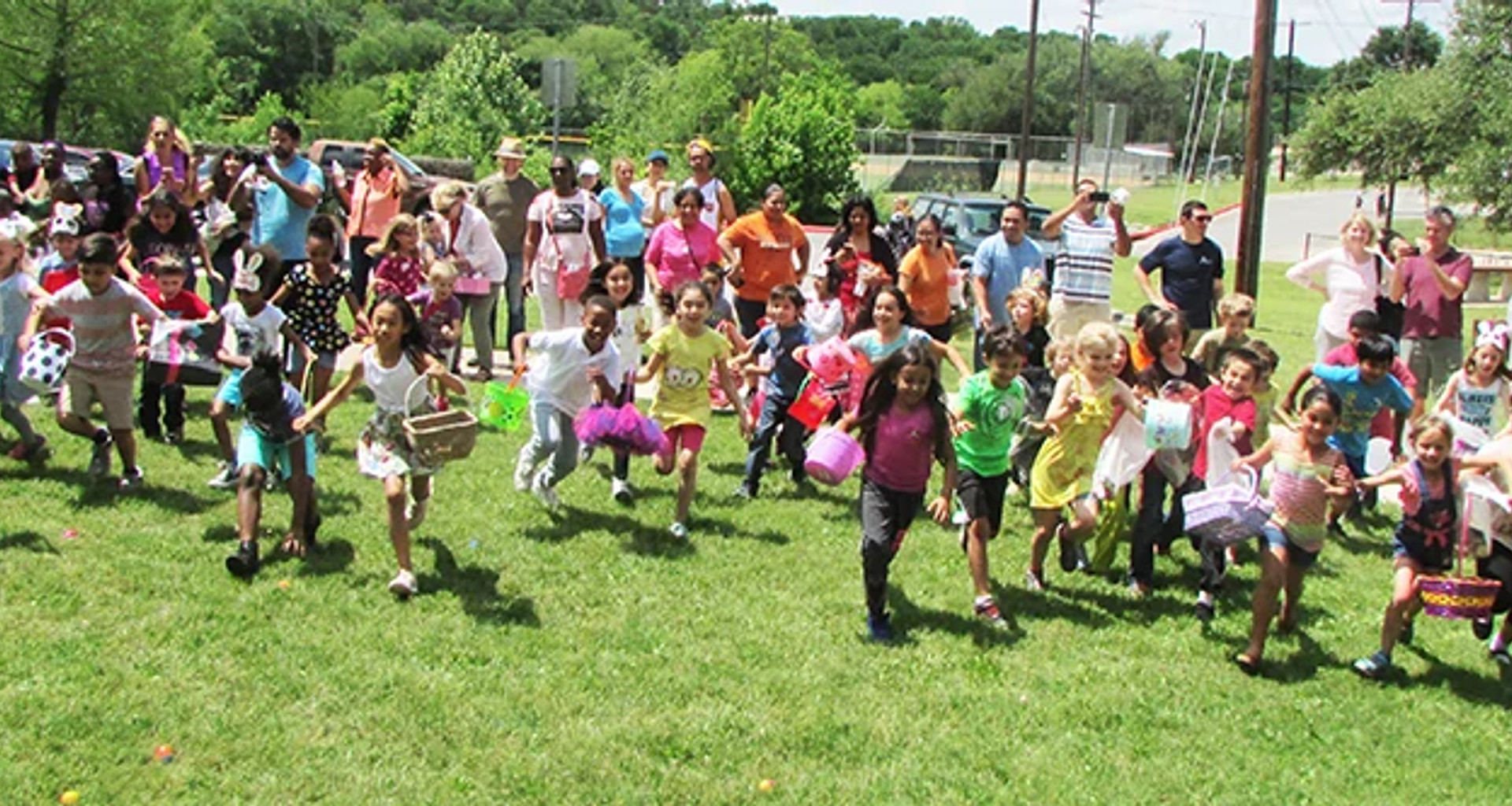 Large group of youth running with Easter baskets